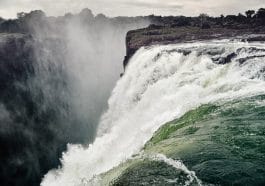 The Victoria Falls, one of the largest falls in the world, is located on the Zambezi River on the border between Zambia and Zimbabwe