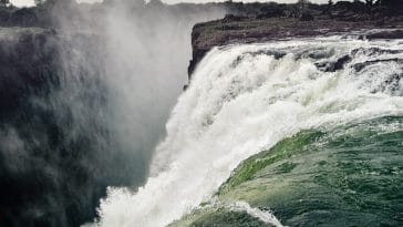 The Victoria Falls, one of the largest falls in the world, is located on the Zambezi River on the border between Zambia and Zimbabwe