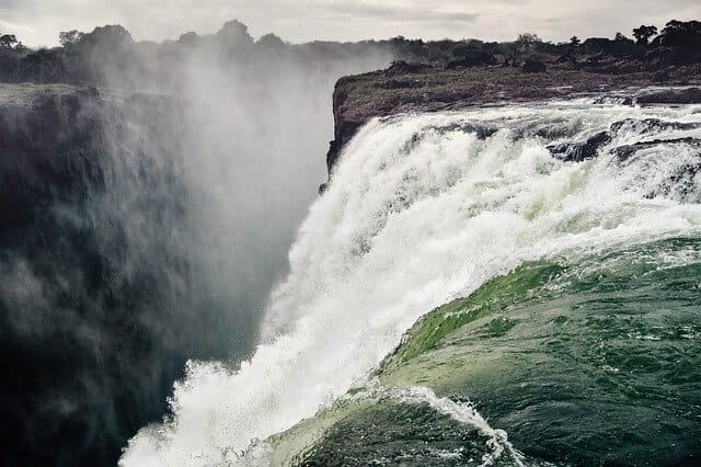 The Victoria Falls, one of the largest falls in the world, is located on the Zambezi River on the border between Zambia and Zimbabwe